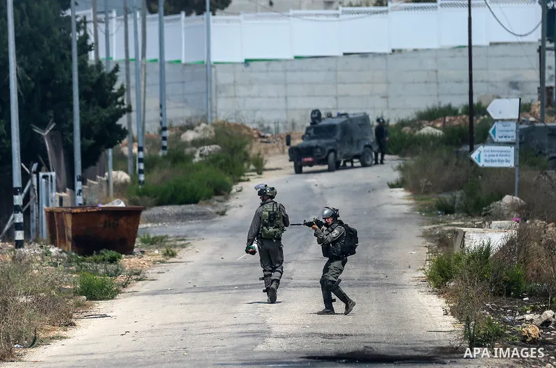 Palestinian protesters clash with Israeli security forces following a demonstration against the death of prisoner Bassam al-Sayeh in an Israeli prison, near the Jewish settlement of Beit El, next to the West Bank city of...