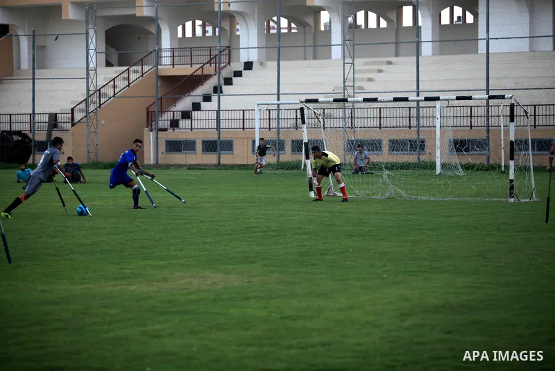 Palestinian amputees using crutches compete during the Palestinian League football match, at Palestine Stadium in Gaza city, September 10, 2019. Photo by Mahmoud Ajjour