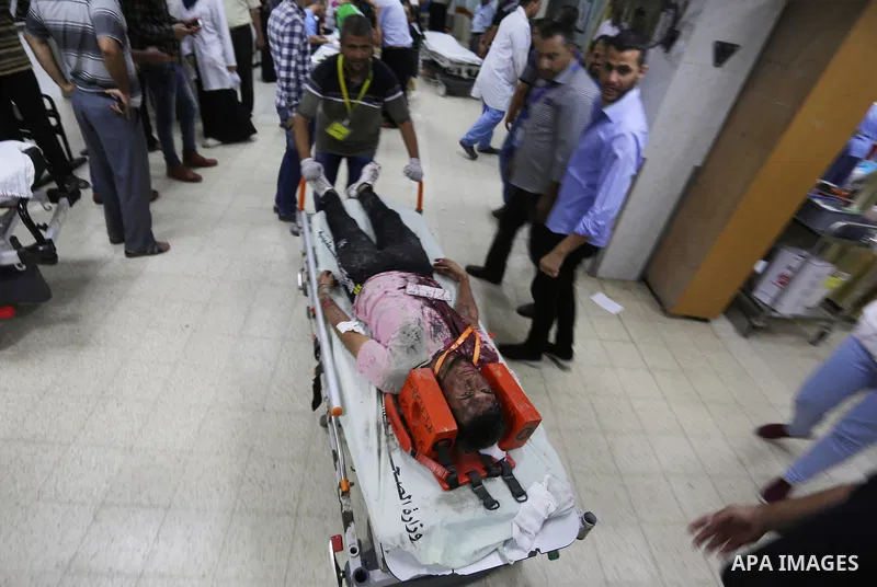 A Palestinian role-playing as an injured person is transported on a moving hospital bed into a hospital during an emergency drill for treating mass casualties organised by French humanitarian organisation Medecins du Mon...