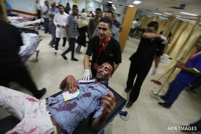 A Palestinian role-playing as an injured person is transported on a moving hospital bed into a hospital during an emergency drill for treating mass casualties organised by French humanitarian organisation Medecins du Mon...