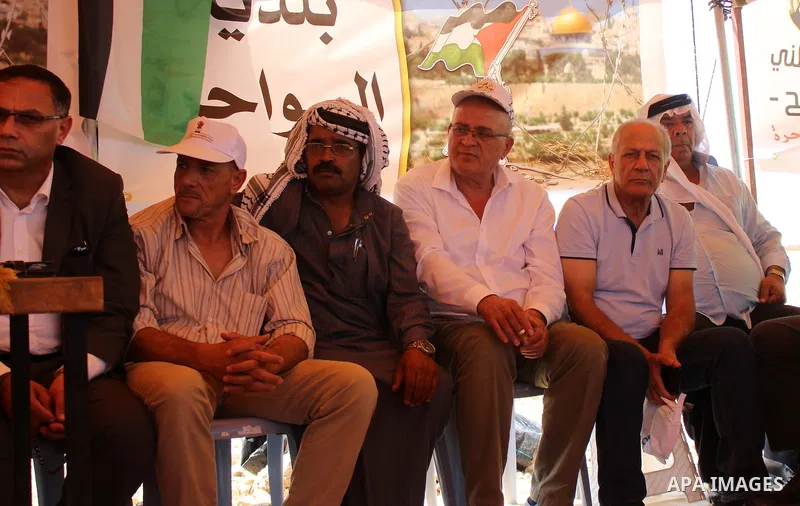 Palestinian activists and land owners hold Palestinian flags and shout during a protest against a new settlement in the West Bank village of Sawahra, east of Jerusalem, 20 September 2019. Photo by Mosab Shawer