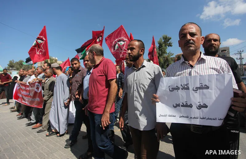 Palestinian supporters of the Democratic Front for the Liberation of Palestine (DFLP), hold placards during a rally in support of the headquarters United Nations Relief and Works Agency (UNRWA), outside its headquarters...
