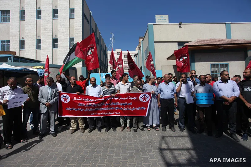 Palestinian supporters of the Democratic Front for the Liberation of Palestine (DFLP), hold placards during a rally in support of the headquarters United Nations Relief and Works Agency (UNRWA), outside its headquarters...