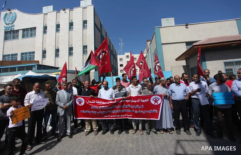 Palestinian supporters of the Democratic Front for the Liberation of Palestine (DFLP), hold placards during a rally in support of the headquarters United Nations Relief and Works Agency (UNRWA), outside its headquarters...