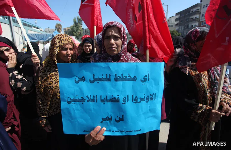 Palestinian supporters of the Democratic Front for the Liberation of Palestine (DFLP), hold placards during a rally in support of the headquarters United Nations Relief and Works Agency (UNRWA), outside its headquarters...