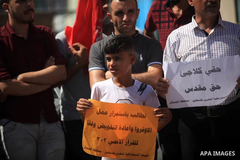 Palestinian supporters of the Democratic Front for the Liberation of Palestine (DFLP), hold placards during a rally in support of the headquarters United Nations Relief and Works Agency (UNRWA), outside its headquarters...