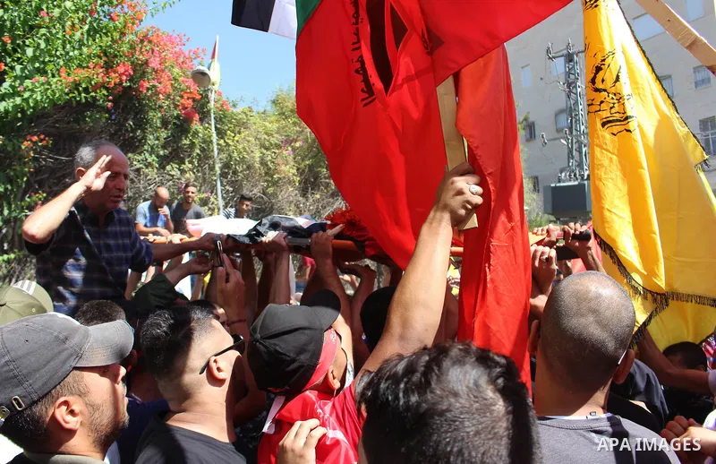 Mourners carry the body of Palestinian Naseem Al-Roumi, 14, was shot dead by Israeli forces for allegedly attempting to carry out a stabbing attack on August and Israeli army kept his body withheld since that, during his...