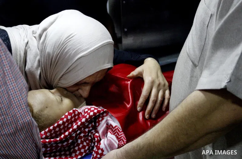 Mourners carry the body of Palestinian Naseem Al-Roumi, 14, was shot dead by Israeli forces for allegedly attempting to carry out a stabbing attack on August and Israeli army kept his body withheld since that, during his...