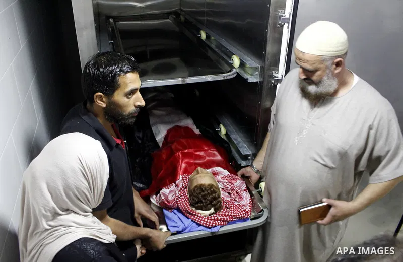 Mourners carry the body of Palestinian Naseem Al-Roumi, 14, was shot dead by Israeli forces for allegedly attempting to carry out a stabbing attack on August and Israeli army kept his body withheld since that, during his...