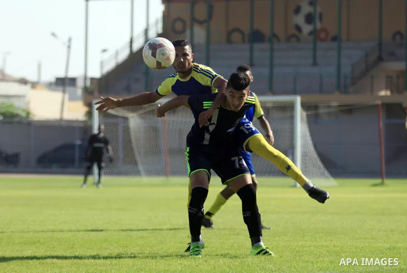 Palestinian football players of Etihad Beit Hanoun (blue) and Alhilal (Dark blue) compete during match premier League in Alyarmuk stadium, in Gaza City on September 22, 2019. Photo by Mahmoud Ajjour