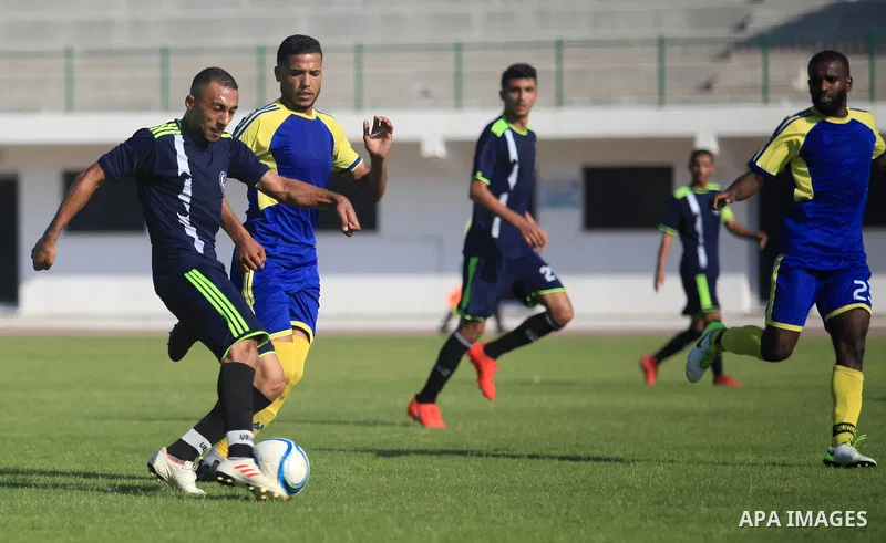 Palestinian football players of Etihad Beit Hanoun (blue) and Alhilal (Dark blue) compete during match premier League in Alyarmuk stadium, in Gaza City on September 22, 2019. Photo by Mahmoud Ajjour
