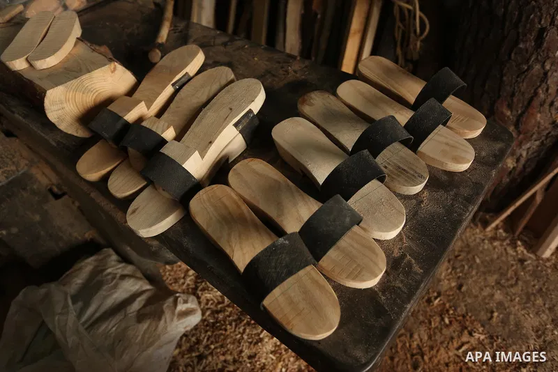 A Palestinian man Waleed Khudair, 69, works on wood to makes the Sabot "wooden shoes" at his workshop in the West Bank city of Nablus, on September 25, 2019. Photo by Shadi Jarar'ah