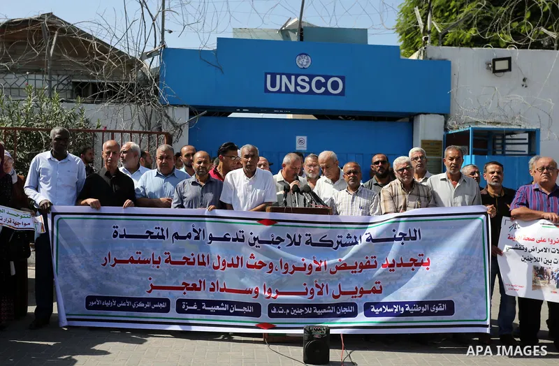 Palestinians, hold placards during a rally in support of the headquarters United Nations Relief and Works Agency (UNRWA), in front of the headquarter United Nation "UNSCO", in Gaza city on September 26, 2019. Photo by As...