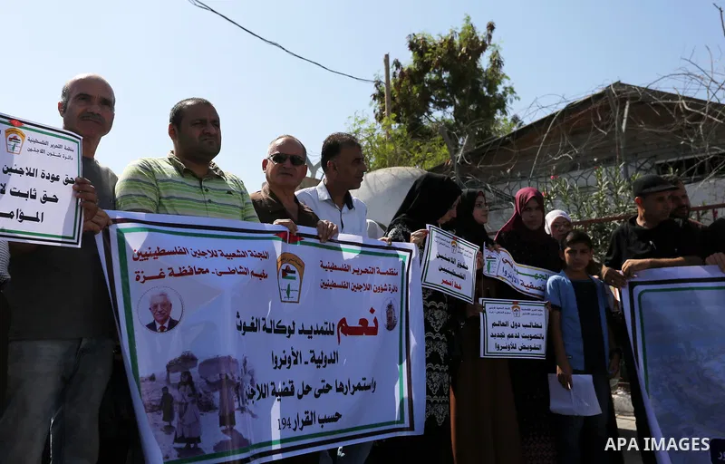 Palestinians, hold placards during a rally in support of the headquarters United Nations Relief and Works Agency (UNRWA), in front of the headquarter United Nation "UNSCO", in Gaza city on September 26, 2019. Photo by As...