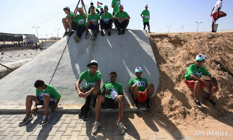 Palestinian racers take part in a marathon "Running for water cross country run" in Rafah in the southern Gaza Strip, on September 26, 2019. Photo by Mahmoud Ajjour