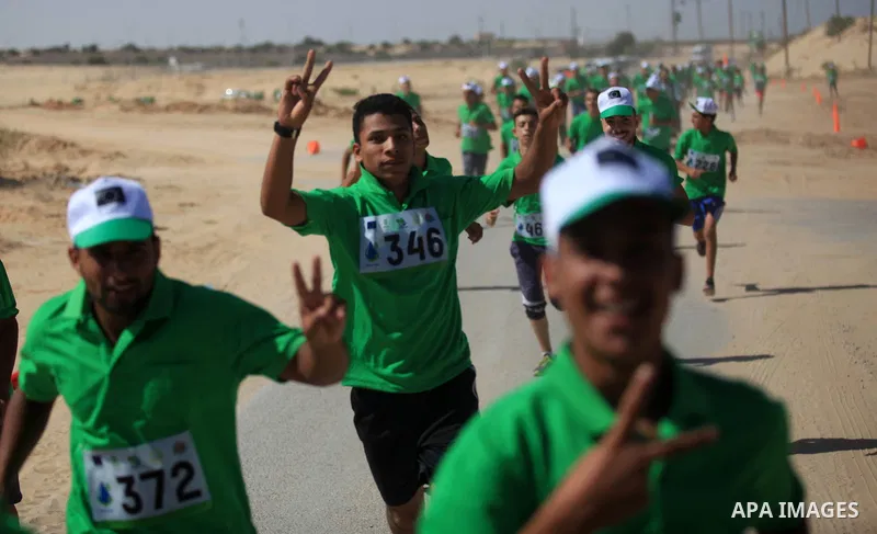Palestinian racers take part in a marathon "Running for water cross country run" in Rafah in the southern Gaza Strip, on September 26, 2019. Photo by Mahmoud Ajjour