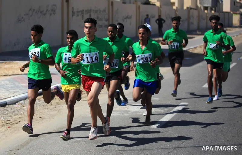 Palestinian racers take part in a marathon "Running for water cross country run" in Rafah in the southern Gaza Strip, on September 26, 2019. Photo by Mahmoud Ajjour