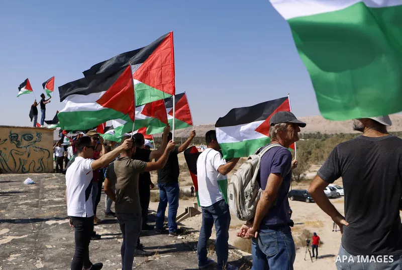 Palestinian demonstrators hold Palestinian flags during a protest against Jewish settlements, near the Dead Sea in the Israeli-occupied West Bank September 28, 2019. Photo by Sleman abo srour \ WAFA