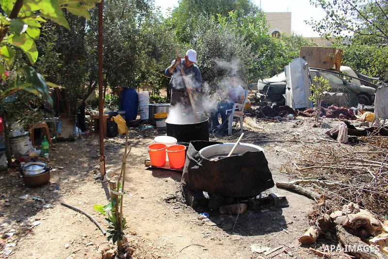 Palestinians prepare a traditional sweets "Malban or Turkish delight" from grape, the West Bank village of Halhul, near Hebron, on September 29, 2019. Hebron is very famous in grape production as it contains many fields...