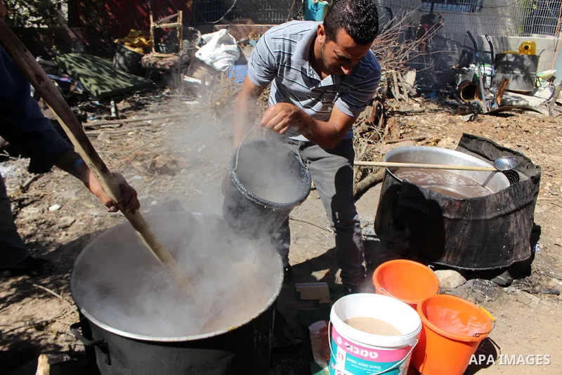 Palestinians prepare a traditional sweets "Malban or Turkish delight" from grape, the West Bank village of Halhul, near Hebron, on September 29, 2019. Hebron is very famous in grape production as it contains many fields...