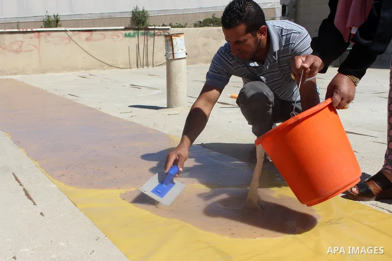 Palestinians prepare a traditional sweets "Malban or Turkish delight" from grape, the West Bank village of Halhul, near Hebron, on September 29, 2019. Hebron is very famous in grape production as it contains many fields...