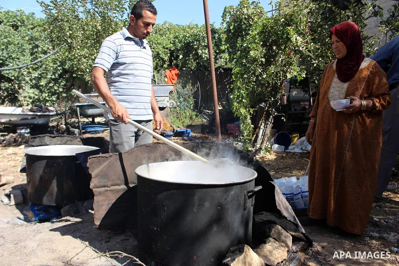 Palestinians prepare a traditional sweets "Malban or Turkish delight" from grape, the West Bank village of Halhul, near Hebron, on September 29, 2019. Hebron is very famous in grape production as it contains many fields...