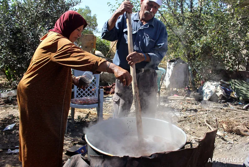 Palestinians prepare a traditional sweets "Malban or Turkish delight" from grape, the West Bank village of Halhul, near Hebron, on September 29, 2019. Hebron is very famous in grape production as it contains many fields...