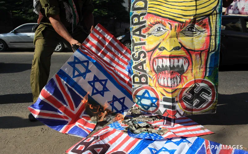 Palestinians burn an Israeli, British and U.S. flags during a protest to show solidarity with Palestinian prisoners held in Israeli jails, in front of Red cross office in Gaza city on September 30, 2019. Photo by Mahmoud...