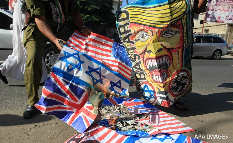 Palestinians burn an Israeli, British and U.S. flags during a protest to show solidarity with Palestinian prisoners held in Israeli jails, in front of Red cross office in Gaza city on September 30, 2019. Photo by Mahmoud...