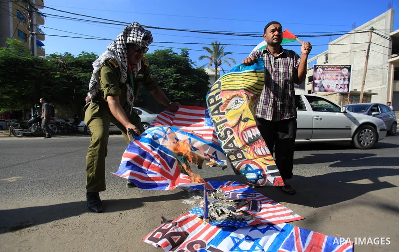 Palestinians burn an Israeli, British and U.S. flags during a protest to show solidarity with Palestinian prisoners held in Israeli jails, in front of Red cross office in Gaza city on September 30, 2019. Photo by Mahmoud...