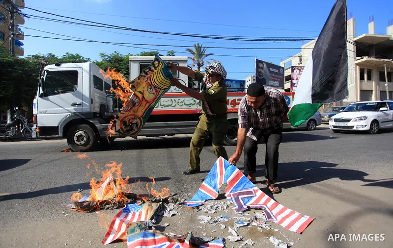 Palestinians burn an Israeli, British and U.S. flags during a protest to show solidarity with Palestinian prisoners held in Israeli jails, in front of Red cross office in Gaza city on September 30, 2019. Photo by Mahmoud...