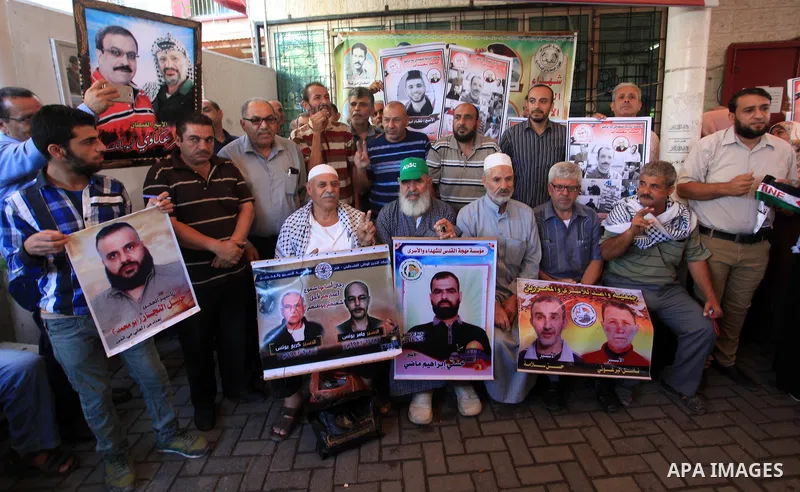 Palestinians take part in a protest in solidarity with prisoners in Israeli jails, in front of the Red cross office, in Gaza city on on September 30, 2019. Photo by Mahmoud Ajjour