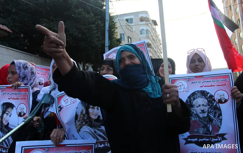 Palestinians take part in a protest in solidarity with prisoners in Israeli jails, in front of the Red cross office, in Gaza city on on September 30, 2019. Photo by Mahmoud Ajjour