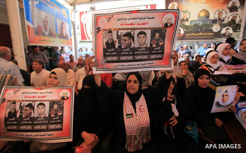 Palestinians take part in a protest in solidarity with prisoners in Israeli jails, in front of the Red cross office, in Gaza city on on September 30, 2019. Photo by Mahmoud Ajjour