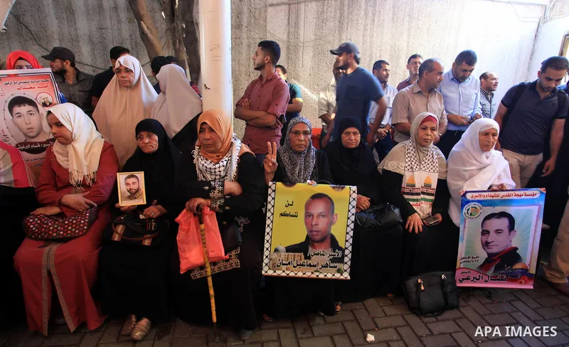Palestinians take part in a protest in solidarity with prisoners in Israeli jails, in front of the Red cross office, in Gaza city on on September 30, 2019. Photo by Mahmoud Ajjour