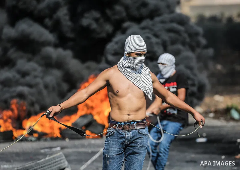 Palestinian protesters clash with Israeli security forces following a demonstration to support Palestinian prisoners held in Israeli jails, near the Jewish settlement of Beit El, next to the West Bank city of Ramallah, o...