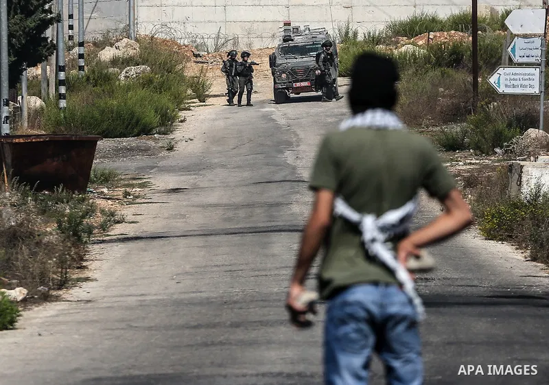 Palestinian protesters clash with Israeli security forces following a demonstration to support Palestinian prisoners held in Israeli jails, near the Jewish settlement of Beit El, next to the West Bank city of Ramallah, o...