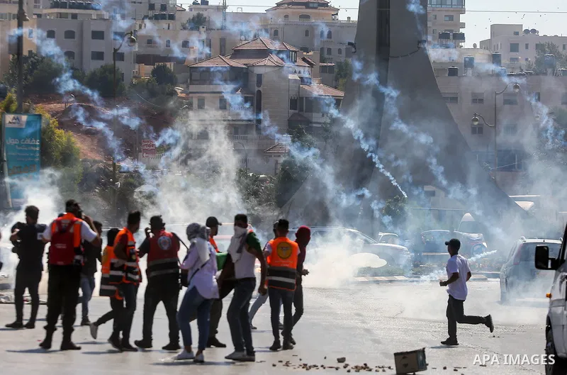 Palestinian protesters clash with Israeli security forces following a demonstration to support Palestinian prisoners held in Israeli jails, near the Jewish settlement of Beit El, next to the West Bank city of Ramallah, o...