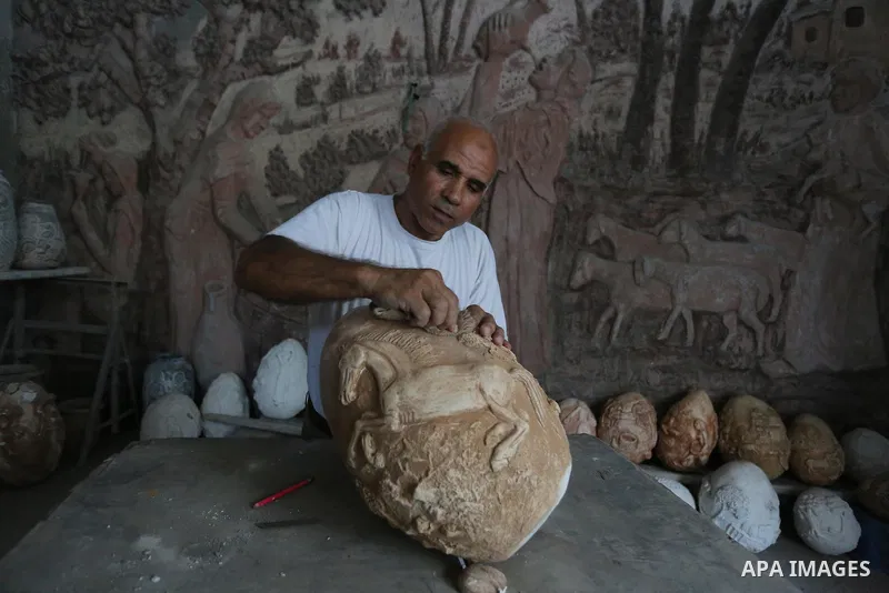 Palestinian artist bassam Alhajjar sculpture on pottery at a workshop in Gaza City on October 3, 2019. Photo by Ashraf Amra