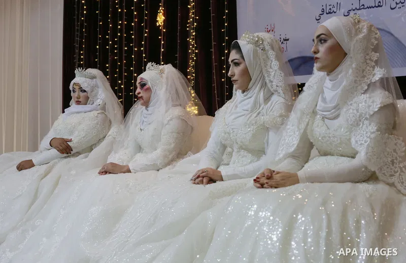 A Palestinian woman wears wedding dress as she takes part an event against violence towards women in Gaza City on October 10, 2019. Photo by Ashraf Amra