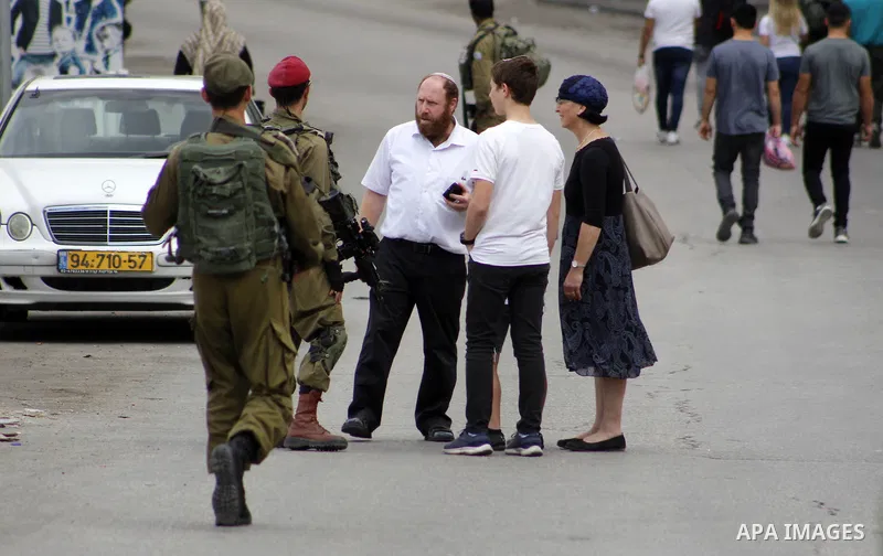 Israeli security forces and Jewish settlers close a street to mark the Sukkot (Feast of Tabernacles) which marks the exodus of the ancient Hebrew people from Egypt, in the West Bank city of Hebron on October 16, 2019. Sa...