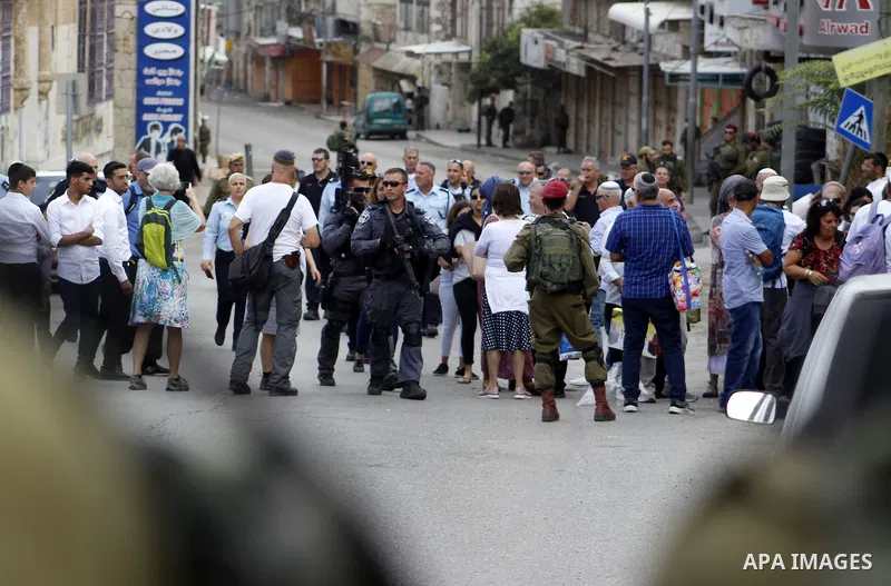 Israeli security forces and Jewish settlers close a street to mark the Sukkot (Feast of Tabernacles) which marks the exodus of the ancient Hebrew people from Egypt, in the West Bank city of Hebron on October 16, 2019. Sa...