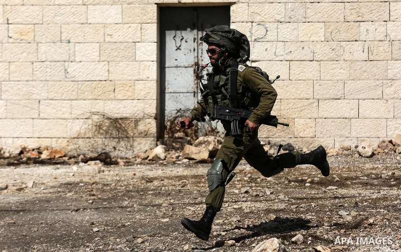 Israeli security forces take position during clashes with Palestinian protesters following a weekly demonstration against the expropriation of Palestinian land by Israel in the village of Kfar Qaddum, near the West Bank...