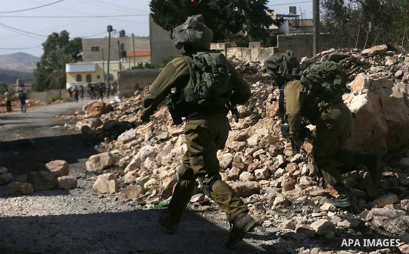 Israeli security forces take position during clashes with Palestinian protesters following a weekly demonstration against the expropriation of Palestinian land by Israel in the village of Kfar Qaddum, near the West Bank...