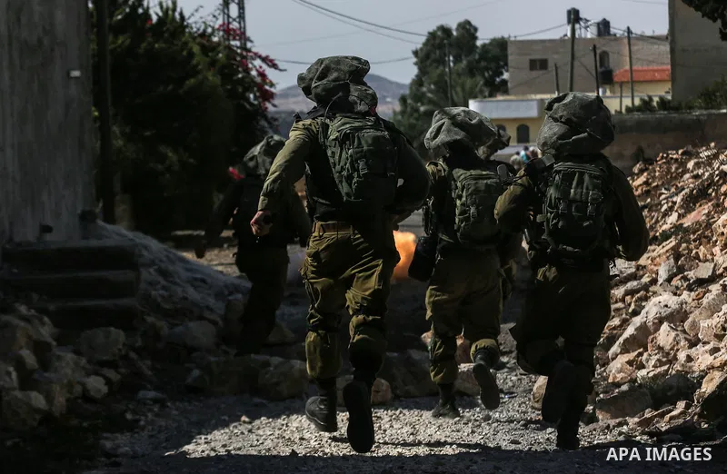 Israeli security forces take position during clashes with Palestinian protesters following a weekly demonstration against the expropriation of Palestinian land by Israel in the village of Kfar Qaddum, near the West Bank...