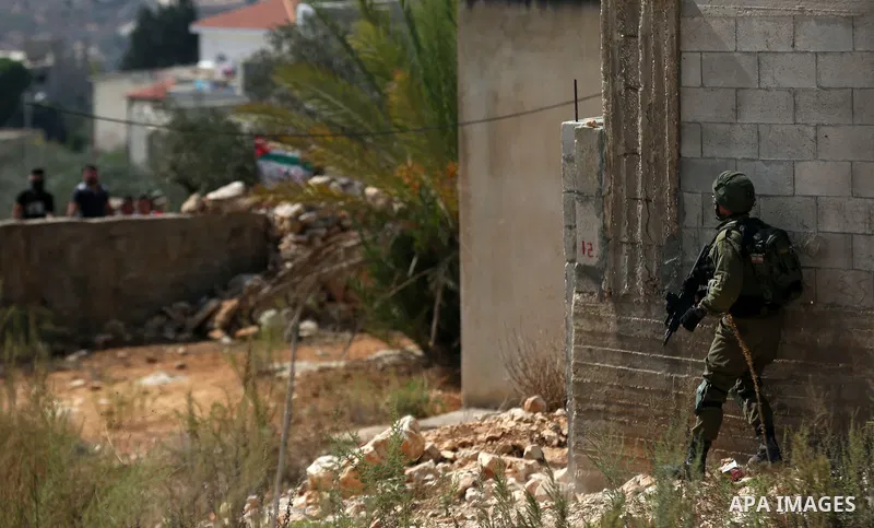 Israeli security forces take position during clashes with Palestinian protesters following a weekly demonstration against the expropriation of Palestinian land by Israel in the village of Kfar Qaddum, near the West Bank...