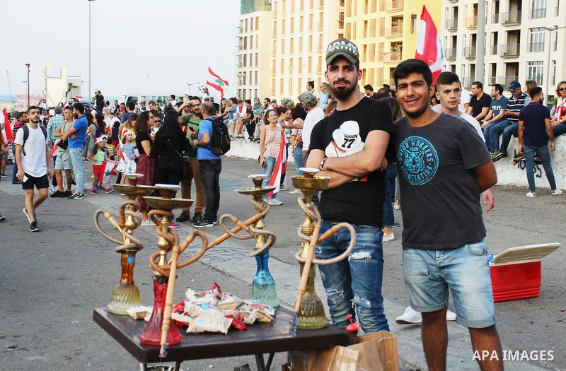 Lebanese demonstrators take part in a protest against dire economic conditions in Beirut on October 22, 2019. Tens of thousands of Lebanese protesters kept the country on lockdown as they gathered for a sixth consecutive...