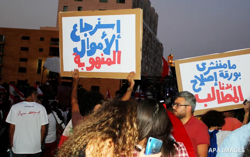 Lebanese demonstrators take part in a protest against dire economic conditions in Beirut on October 22, 2019. Tens of thousands of Lebanese protesters kept the country on lockdown as they gathered for a sixth consecutive...