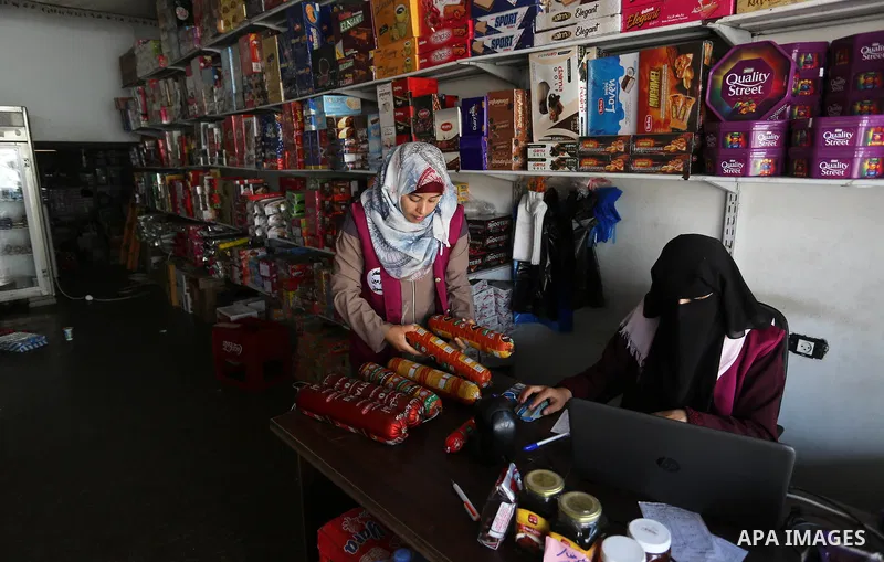 Palestinian graduates work in al-Haramain Supermarket in Deir Al-Balah in the central of Gaza Strip on October 27 2019. Photo by Ashraf Amra