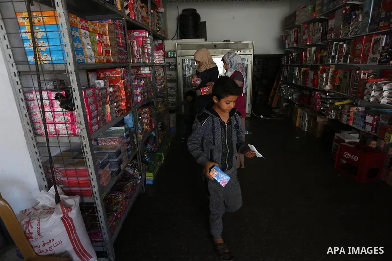 Palestinian graduates work in al-Haramain Supermarket in Deir Al-Balah in the central of Gaza Strip on October 27 2019. Photo by Ashraf Amra